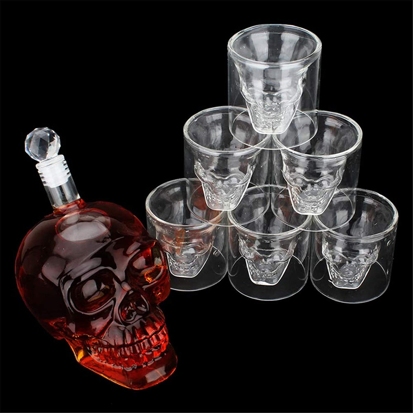 Skull-shaped bottle with six matching skull glasses on a black background
