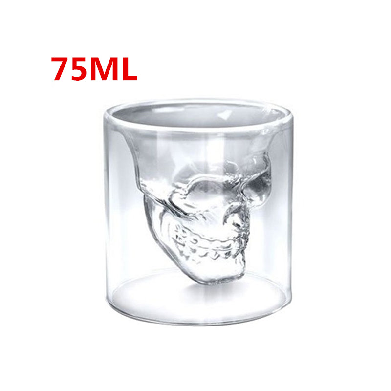 Clear glass skull-shaped shot glass with '75ML' text on a white background
