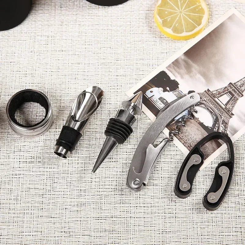 a closeup view drip ring , pourer, stopper, corkscrew and foil cutter from deluxe 5-piece wine tool kit for precise pouring without spills