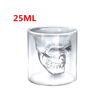 Clear glass skull-shaped shot glass with '25ML' text on a white background