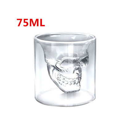 Clear glass skull-shaped shot glass with '75ML' text on a white background