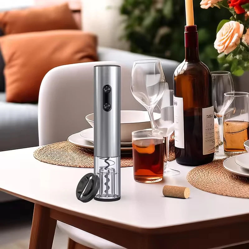 Electric wine opener with foil cutter on a set dining table with plates, wine glasses and a half-full wine bottle