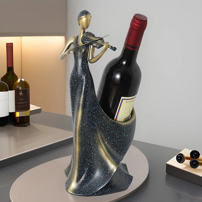 Decorative wine bottle holder shaped like a woman holding a wine bottle on a table.

