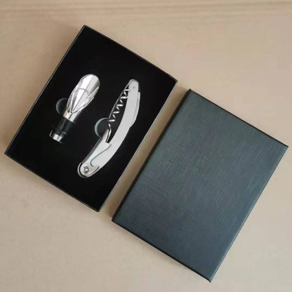 Corkscrew and pourer set in a black box on a beige surface