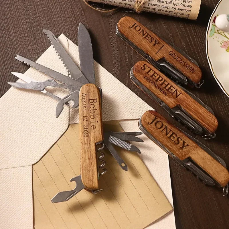 Set of personalized wooden multi-tool knives on a wooden surface with a notepad.