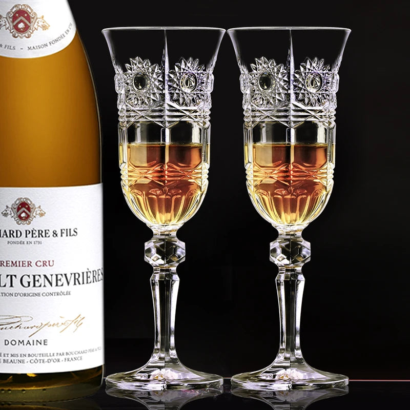 Two elegant crystal champagne flutes filled with sparkling golden wine beside a bottle of Dom Pérignon, set on a refined celebration table capturing luxury toast moment and fine dining atmosphere.