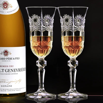 Two elegant crystal champagne flutes filled with sparkling golden wine beside a bottle of Dom Pérignon, set on a refined celebration table capturing luxury toast moment and fine dining atmosphere.