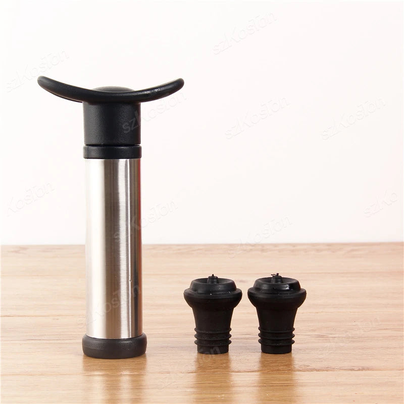 Vacuum wine preserver with two black nozzles on a wooden surface