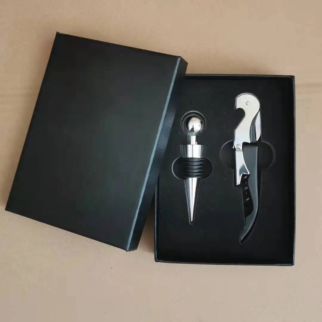 Wine bottle opener and stopper set in a black box on a beige background