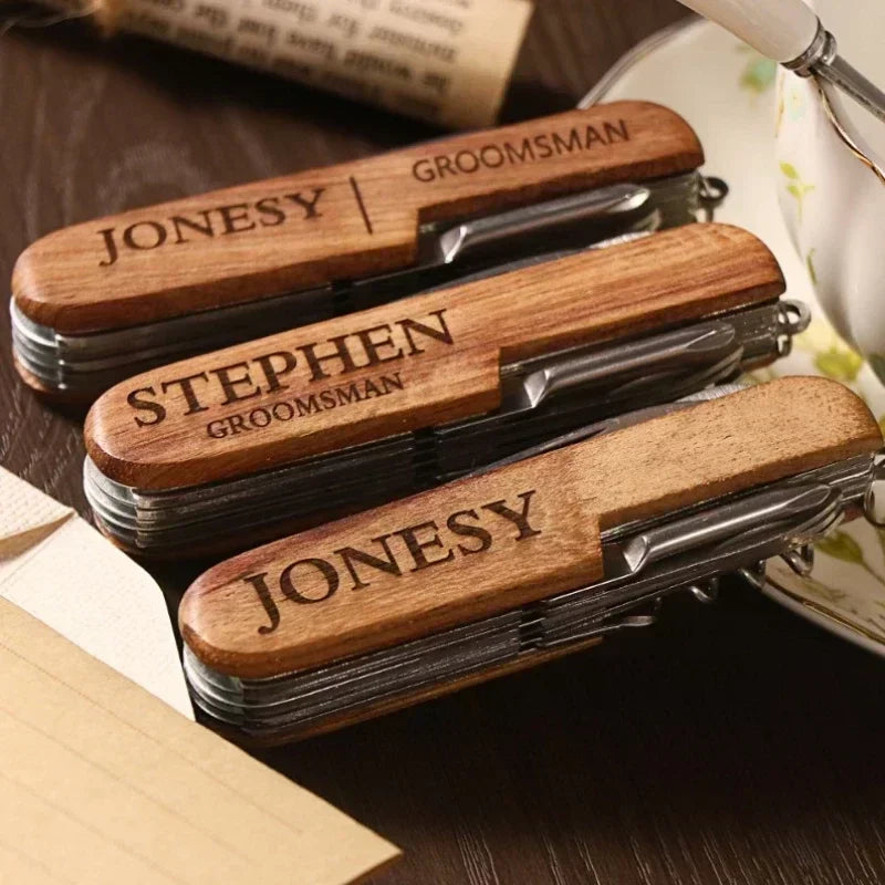 Three wooden pocket knives with engraved names on a wooden surface.