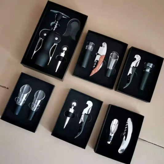 Set of wine openers in black boxes on a beige surface