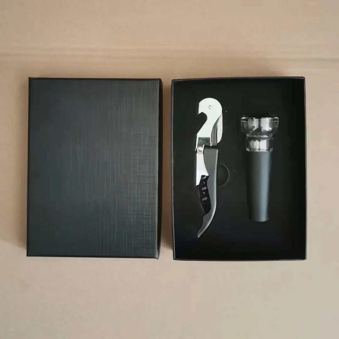 Charcoal Handle Corkscrew with stopper in black boxes on a beige surface
