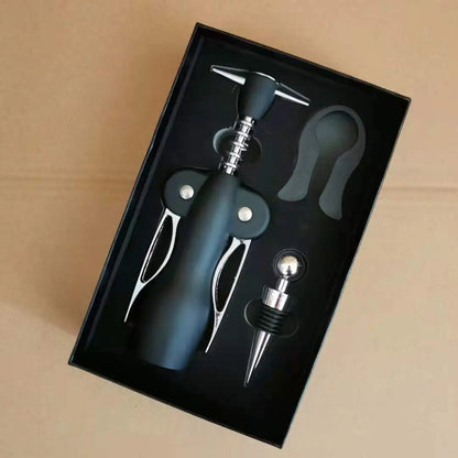 Rabbit Ear Wine opener set with bottle stopper and foil cutter in a black box on a beige background