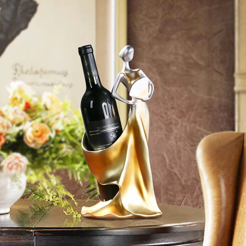 Decorative wine bottle holder with a bottle on a table with flowers in the background