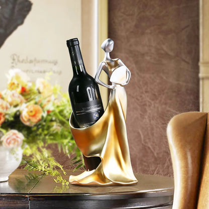 Decorative wine bottle holder with a bottle on a table with flowers in the background