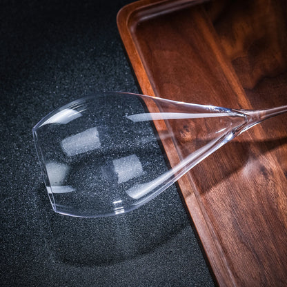 CRISON crystal glassware piece on a wooden tray against a dark surface, showcasing elegant design for refined hosting and table presentation