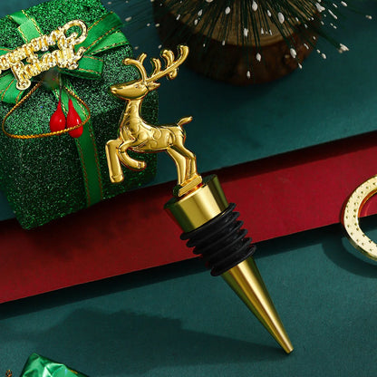 Gold deer-shaped bottle stopper with a green gift and red ribbon in the background