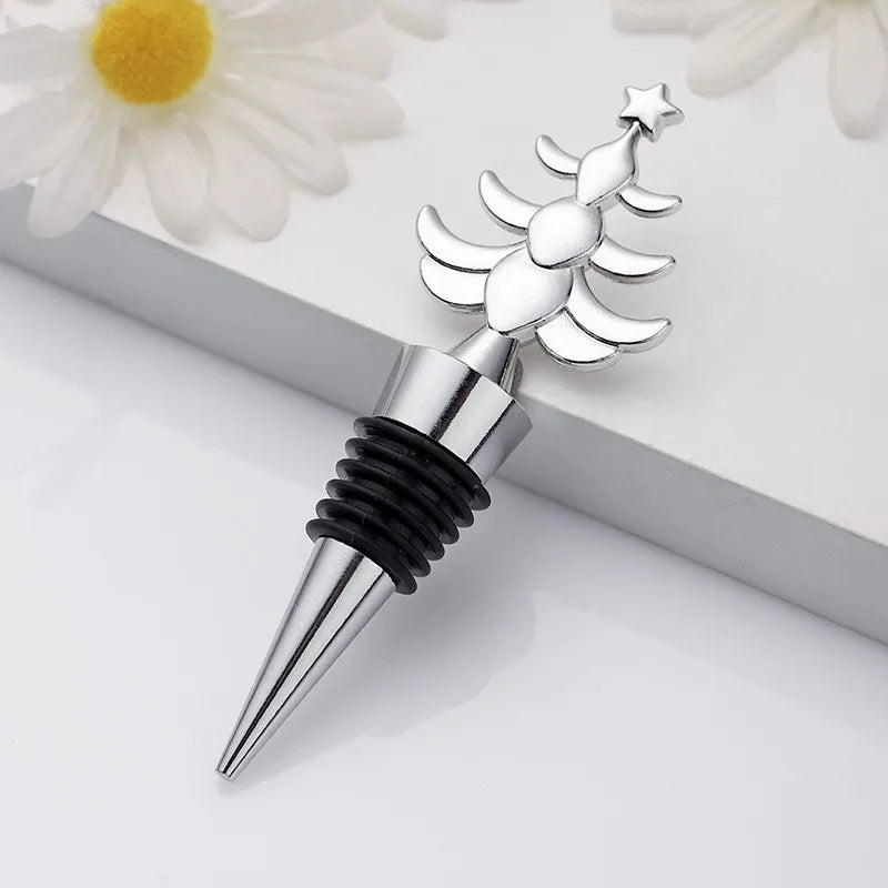 Decorative bottle stopper with celestial design on a white surface with flowers in the background
