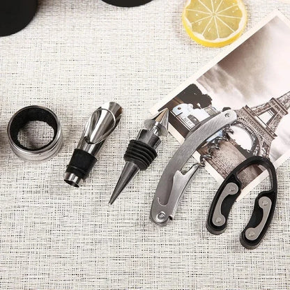 “Flat lay of 5 wine tools including corkscrew, foil cutter, and stopper”

