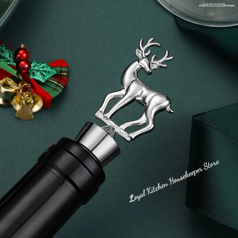 Silver reindeer bottle stopper on a dark green surface with Christmas decorations.