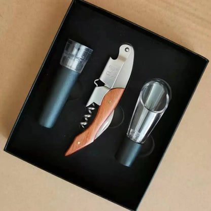 Wine opener set with bottle stopper, pourer and corkscrew in a black box on a beige background