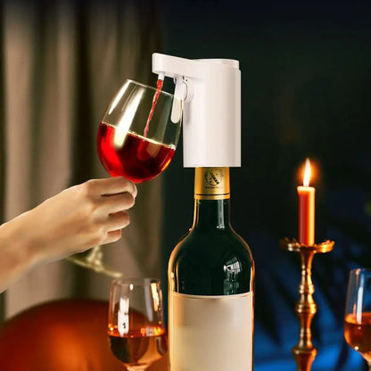 Person pouring red wine into a glass using an induction wine dispenser with a candlelit background.