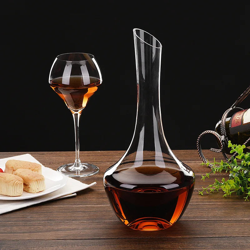 Handcrafted crystal wine decanter catching ambient light on a rustic bar.