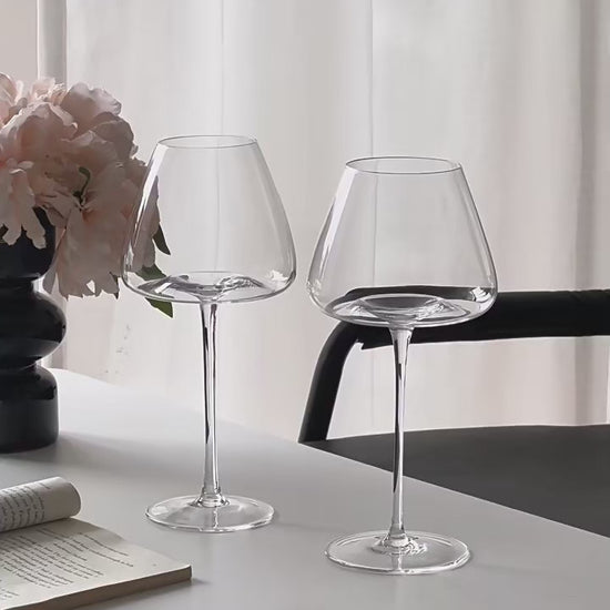Video showing two sizes of Burgundy crystal wine glasses, with wine being poured into the larger sized glass to demonstrate capacity and elegant stemware design