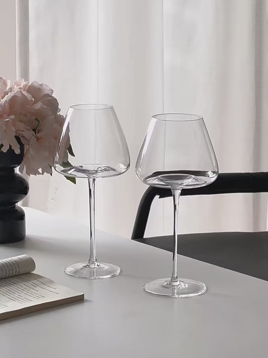 Video showing two sizes of Burgundy crystal wine glasses, with wine being poured into the larger sized glass to demonstrate capacity and elegant stemware design
